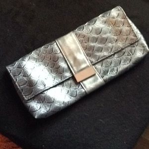 Redken brand silver scale clutch.